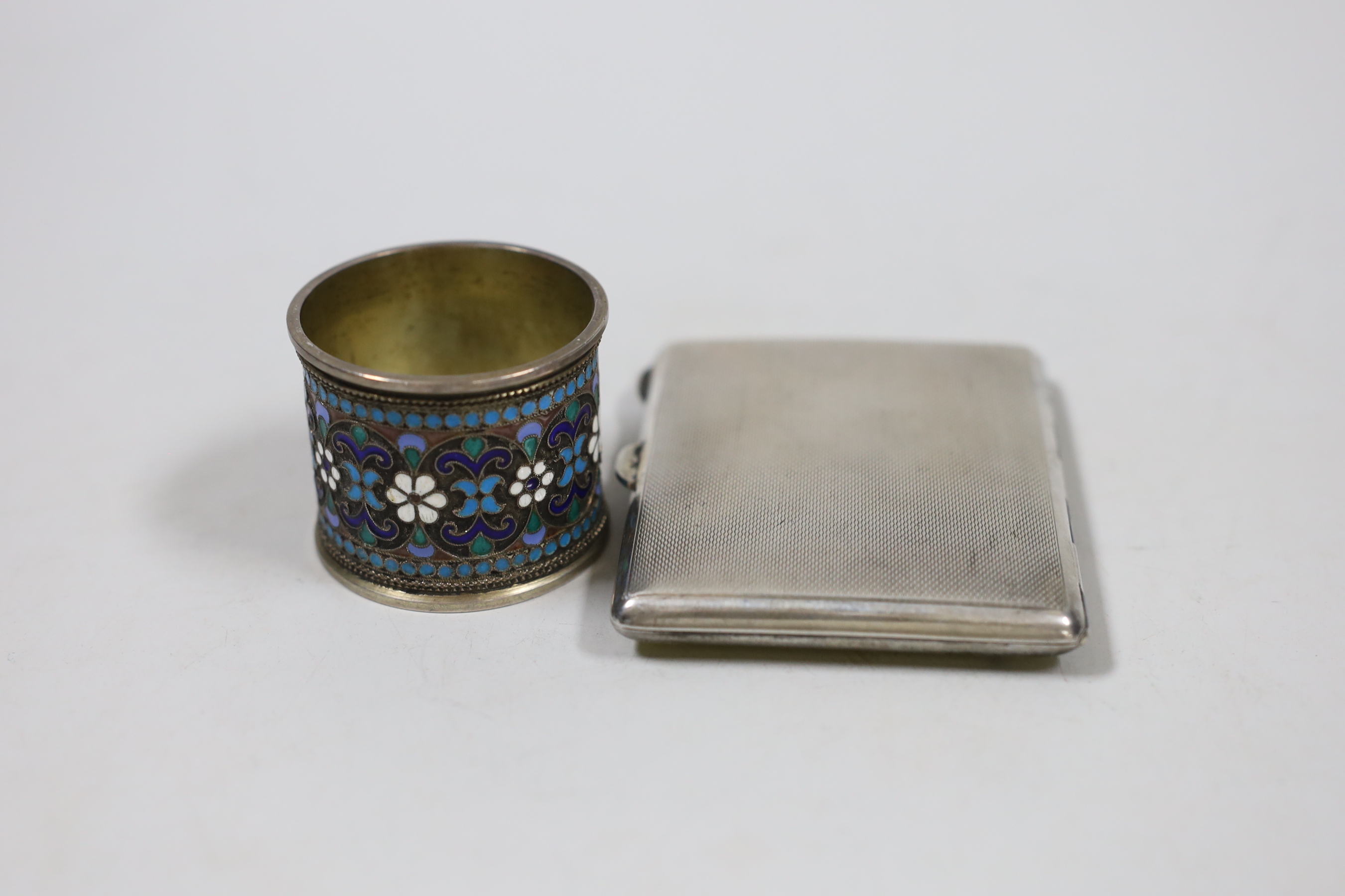 A George V silver and enamelled cigarette case, Birmingham, 1935, 85mm and an early 20th century Russian 84 zolotnik and cloisonné enamelled napkin ring.